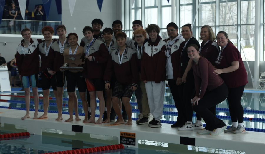 WA Boys' Swim and Dive and their coaches pose for a picture at their state meet.
